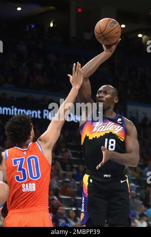 Oklahoma City Thunder center Olivier Sarr, right, dunks over Memphis  Grizzlies forward Brandon Clarke (15) in the first half of an NBA  basketball game Sunday, March 13, 2022, in Oklahoma City. (AP