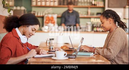 Students writing, studying on laptop in cafe for elearning, university education or working remote. Black women, friends and college research in Stock Photo