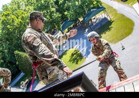 Staff Sgt. Angelo Iezzi, an instructor with Company B, 399th Regiment (Cadet Summer Training), guides a cadet down the open wall from the rappel tower on Fort Knox, Ky. Soldiers from 4th Battalion, 399th Regiment, will lead thousands of Reserve Officers' Training Corps cadets from across the country through the confidence/obstacle course and rappel tower at Fort Knox this summer starting in early June. Stock Photo