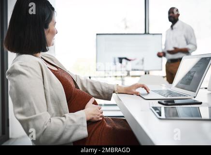 You can make a baby and make it happen. a pregnant young businesswoman having a team meeting in a modern office. Stock Photo