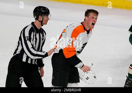 Arizona Coyotes defenseman Josh Brown (3) lands a punch during a fight  against San Jose Sharks center Michael Eyssimont as linesman Devin Berg,  left, looks on during the first period of an