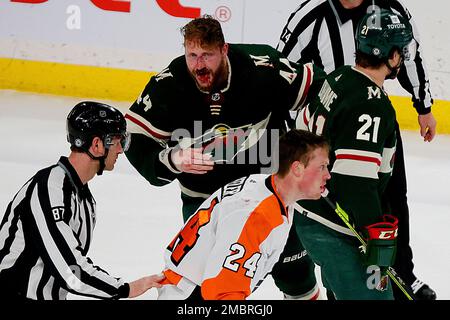 Arizona Coyotes defenseman Josh Brown (3) lands a punch during a fight  against San Jose Sharks center Michael Eyssimont as linesman Devin Berg,  left, looks on during the first period of an