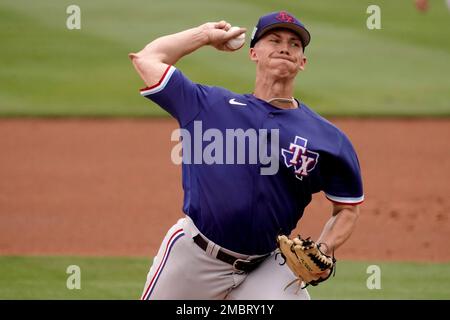 Texas Rangers starting pitcher Glenn Otto throws during the first inning of  a spring training baseball game against the Seattle Mariners Monday, March  28, 2022, in Peoria, Ariz. (AP Photo/Charlie Riedel Stock