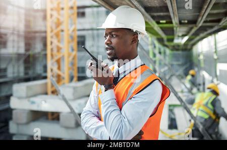 Effective communication for better construction. a young man using a walkie talkie while working at a construction site. Stock Photo