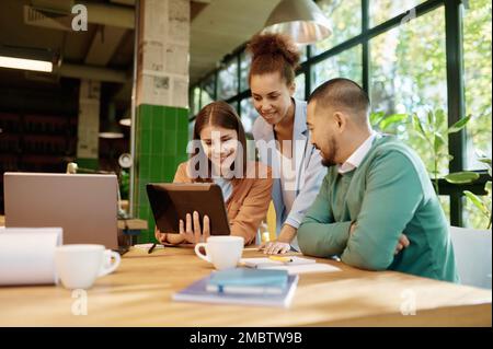 Multiracial office coworker team using digital tablet Stock Photo