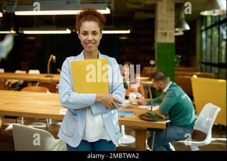 Portrait of freelancer standing in modern coworking space Stock Photo