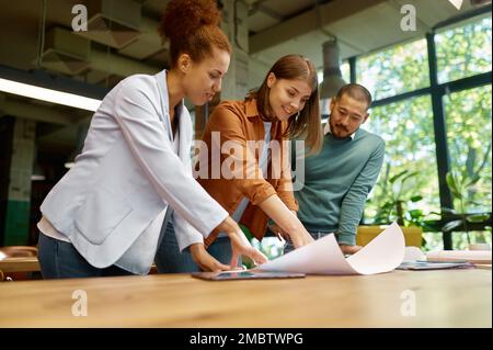 Group of designers multiethnic team discussing affairs at coworking office Stock Photo