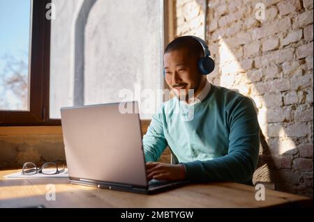 Young man freelancer working online in coworking office Stock Photo