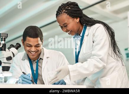 This is just the lead we need. two scientists working together in a lab. Stock Photo