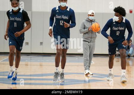 st peters coach shaheen holloway second from right watches as his players warm up during ncaa college basketball practice tuesday march 22 2022 in jersey city nj ap photoseth wenig 2mbwh19