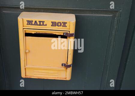 mail post text sign on yellow old private mailbox of vintage house Stock Photo