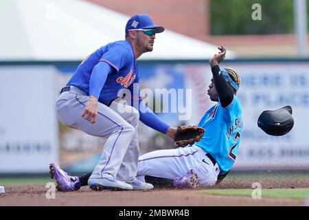 Miami Marlins' Jazz Chisholm loses his helmet as he runs to first