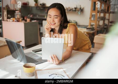 Tablet, e commerce and woman or small business owner smile for profit, sales and startup loan for investment. Online banking, success and asian person Stock Photo