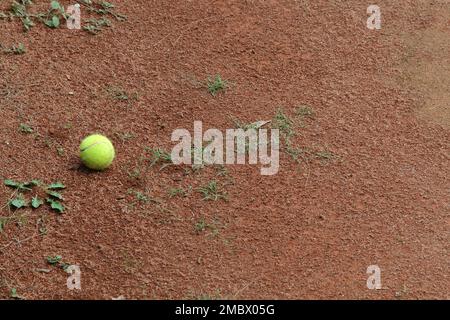 tennis ball in red clay tennis court Stock Photo