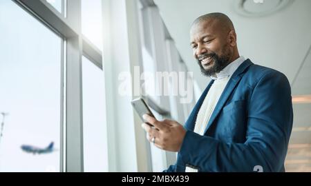 Email, travel and black man with a phone at the airport for connection, communication and work update. Happy, executive and African businessman Stock Photo