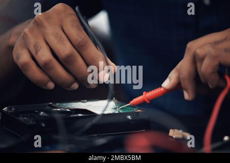 Hes hardwired to handle any problematic tech. an unrecognisable technician repairing computer hardware. Stock Photo