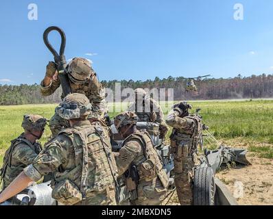 Georgia Army National Guard Soldiers from Charlie Battery, 1st Battalion, 118th Field Artillery Regiment, prepare an M777 Howitzer to be airlifted by a CH-47 Chinook during air assault raid training, June 22, 2022 on Fort Stewart, Ga. During the training, embedded observer, coach/trainers assigned to 188th Infantry Brigade coached the Soldiers as they performed the air assault raid to ensure proper procedures were followed. Stock Photo