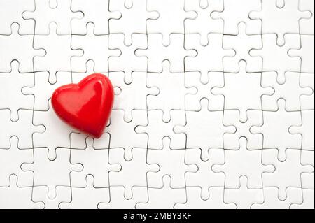 valentine red heart and blank white jigsaw puzzle Stock Photo
