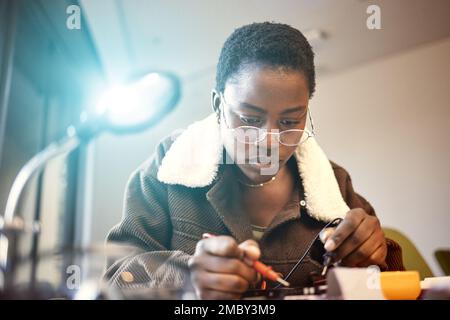 Black woman, student and engineer with electrical project while learning and studying. Education, engineering or technician at college with technology Stock Photo