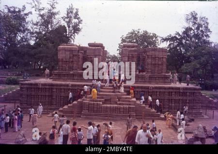 Konark Sun Temple is a 13th-century CE Sun temple at Konark  northeast from Puri city on the coastline in Puri district, Odisha, India. The temple is attributed to king Narasimhadeva I of the Eastern Ganga dynasty about 1250 CE. On the shores of the Bay of Bengal, bathed in the rays of the rising sun, the temple at Konarak is a monumental representation of the sun god Surya's chariot; its 24 wheels are decorated with symbolic designs and it is led by a team of six horses. One can witness three images of Sun God at three directions to catch the rays of the Sun at dawn, noon and sunset. Stock Photo