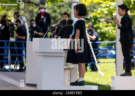 Honona Tokumoto, a student of Okinawa City Yamauchi Elementary School, reads Poem for Peace during the 2022 Memorial Ceremony for All War Dead in Okinawa, at Peace Memorial Park, Okinawa, Japan, June 23, 2022. Every year, the Okinawa Prefecture Government selects a poem written by an elementary student with the theme of peace to be read at the memorial ceremony.  Leaders from across Okinawa gathered during the ceremony to honor the lives that were lost during the Battle of Okinawa. Stock Photo