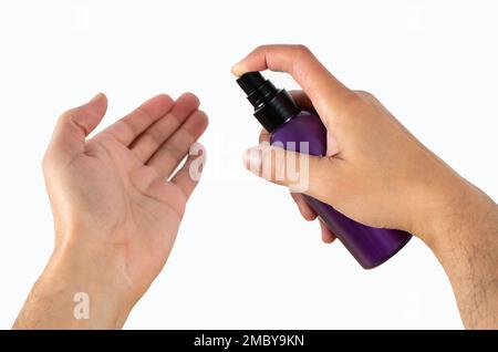 Cosmetic bottle, men’s hand using lotion, body care, skin care with white background Stock Photo