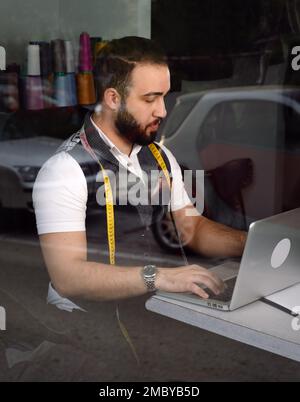 Tailor man working at his atelier Stock Photo