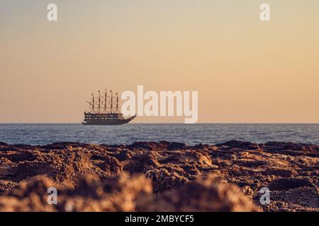 Tourist excursion ship sails in the Mediterranean Sea, view from the shore. Vacation, travel and tourism concept by ship Stock Photo