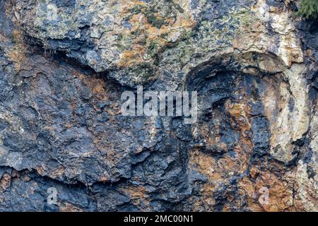 Colorfull stone wall containing minerals. Stock Photo