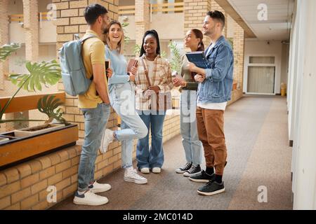 College, friends and happy with students on campus with books for learning, scholarship or knowledge. Study, education or university with people Stock Photo