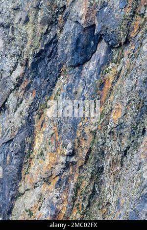 Colorfull stone wall containing minerals. Stock Photo