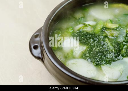 Tteokguk, Korean Seaweed fulvescens Sliced Rice Cake Soup : Oval-shaped rice cake cooked in broth. A traditional Lunar New Year dish. Clear beef broth Stock Photo