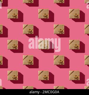 Seamless pattern of golden gift box over red pink background. Repeating pattern of square gift box casts shadow on a pastel viva magenta surface. Gift Stock Photo