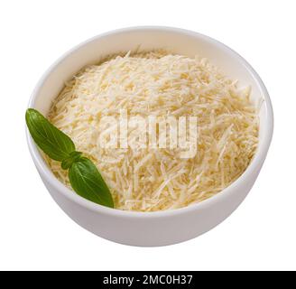 Bowl of shredded parmesan cutout. Grated grana padano cheese in a white bowl isolated on white background. Delicious hard cheese prepared for cooking. Stock Photo