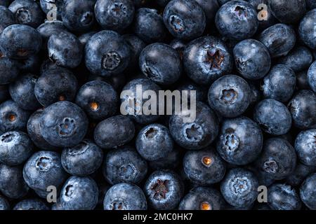 Fresh blueberries background. Texture of ripe juicy wildberries. Sweet blueberry for vegetarian desserts and vitamin vegan snacks. Natural antioxidant Stock Photo