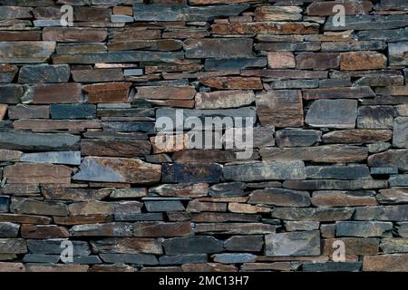 Old traditional slate slabs wall, rustic abstract background Stock Photo