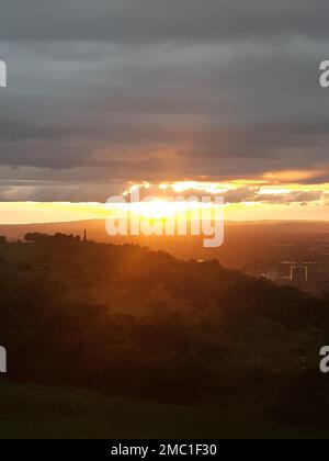A mesmerizing view of the golden sunset over the sea with a flock of ...