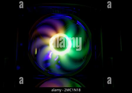 Computer cooler with RGB LED light. Computer circuit board and CPU cooling fans illuminated Stock Photo