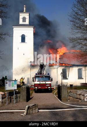 A fire in a workshop at lunchtime on Thursday had devastating consequences for the church in Älvestad between Klockrike and Fornåsa in Motala municipality, Sweden. The fire spread to the roof of Älvestad church, whose oldest parts date from the 12th century. The church was completely destroyed and two people were injured in the fire, including a fireman. Stock Photo