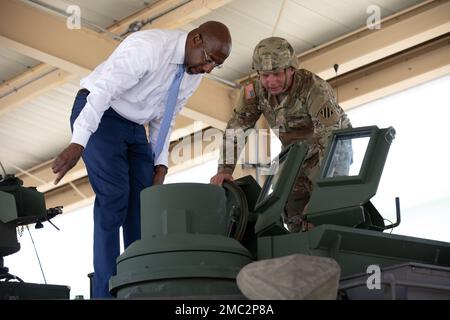 Staff Sgt. Franklin Faircloth, an M1 armored vehicle crew member assigned to 6th Squadron, 8th Cavalry Regiment, 2nd Armored Brigade Combat Team, 3rd Infantry Division, shows U.S. Senator from Georgia Raphael Warnock an M1A2 SEPv3 Abrams Tank at a unit motor pool during a tour of Fort Stewart, Georgia, June 24, 2022. Warnock visited to learn about modernization, readiness and capabilities of the 3rd ID. He also observed and was informed about renovation projects geared towards improving the quality of life and welfare for 3rd ID Soldiers and Families. Stock Photo