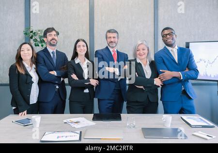 Diverse team of happy young people standing together. Multi-ethnic group of colleagues standing in line, arms folded and smiling. Concepts of teamwork Stock Photo