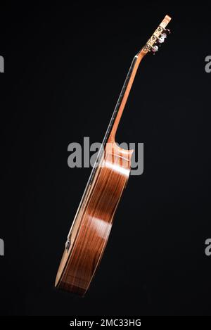 Classical guitar top isolated on black background with a beautiful mosaic rosette, view from the top side. Beautiful Brazilian wood - Pau Ferro Stock Photo