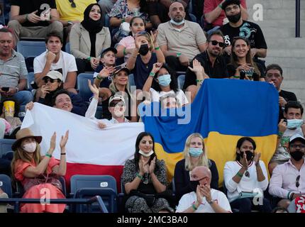 Fans hold a Ukraine national flag next to a Polish flag during a semifinal tennis match between Russia's Andrey Rublev and Poland's Hubert Hurkacz at the Dubai Duty Free Tennis Championship in Dubai, United Arab Emirates, Feb. 25, 2022. (AP Photo/Kamran Jebreili)