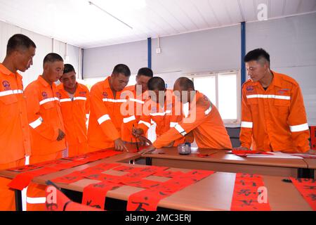 Bandung, Indonesia. 21st Jan, 2023. Construction workers of the Jakarta-Bandung High-Speed Railway write Spring Festival couplets after work in celebration of the upcoming Chinese Lunar New Year in Bekasi, Indonesia, Jan. 21, 2023. Credit: Xu Qin/Xinhua/Alamy Live News Stock Photo