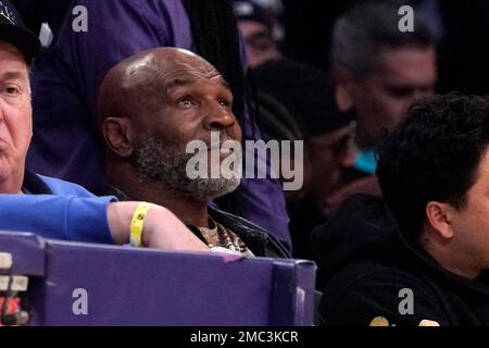 Boxing legend Mike Tyson watches during the first half of an NBA