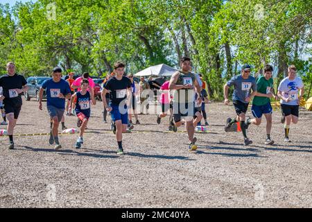 Participants of the Filthy Mudder Mud Run launch from the starting line June 24, 2022, at Malmstrom Air Force Base, Mont. Participants had to overcome multiple mud-based obstacles and challenges in order to finish the race. Stock Photo