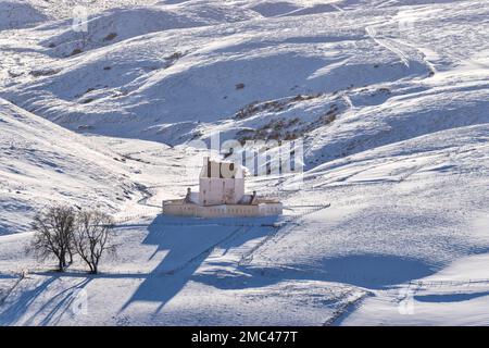 Corgarff Castle Cairngorms National Park Aberdeenshire Scotland the castle building in winter and hills of snow Stock Photo