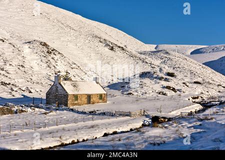 Tomintoul Moray Scotland Glenlivet Estate remote house the Lecht Road A 939 in winter and snow covered hills Stock Photo