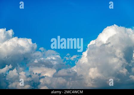 Dramatic image of bright blue sky with fluffy white clouds Stock Photo
