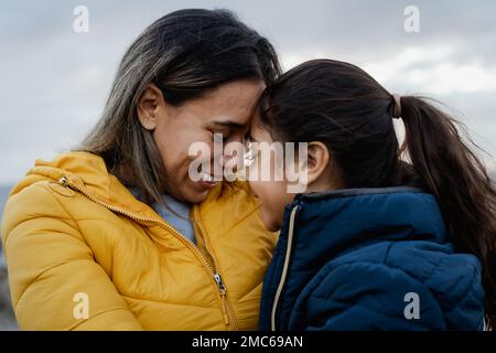 Happy Latin mother with her daughter having tender moment outdoor - Family and love concept Stock Photo